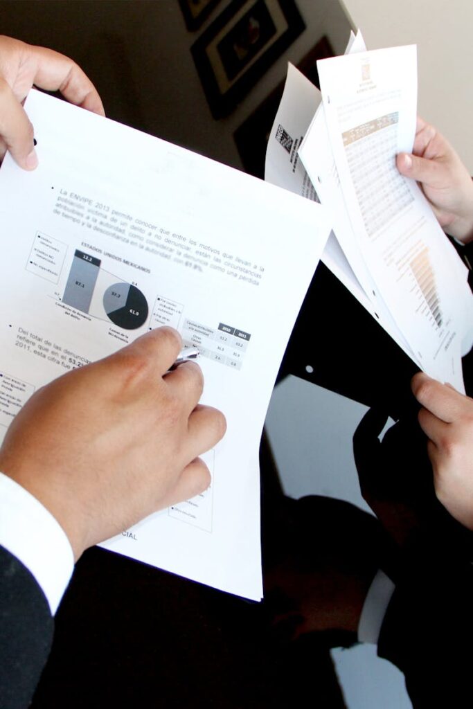 pexels photo 259006 259006 2 A business team reviewing charts and graphs on documents, emphasizing data analysis and teamwork.